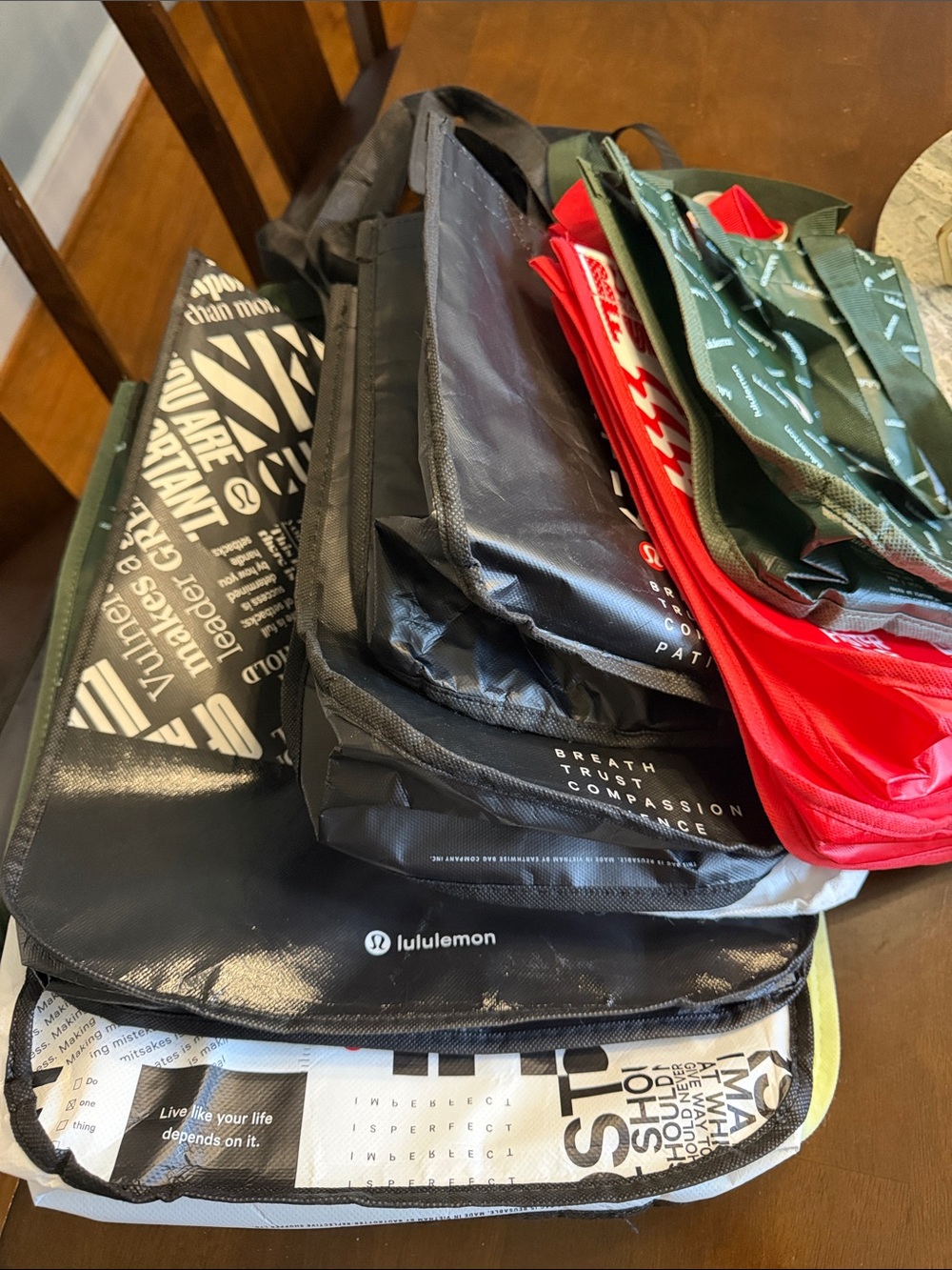 lululemon athletica assorted totes and colors.